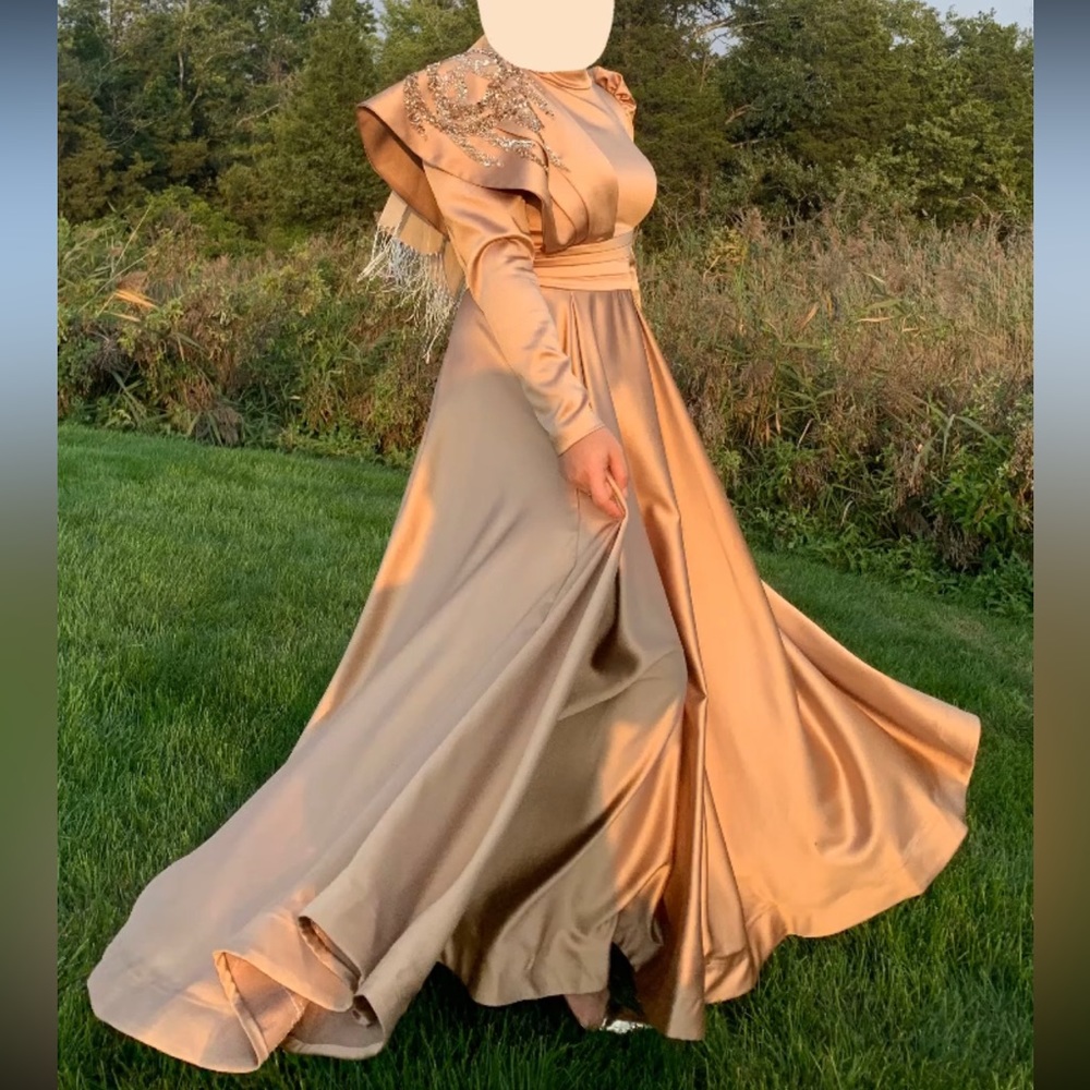 A gold dress that with gold embroidery.